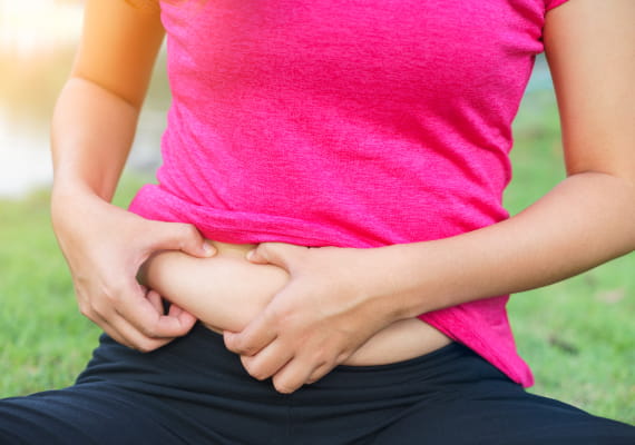 Woman checking her belly fat.