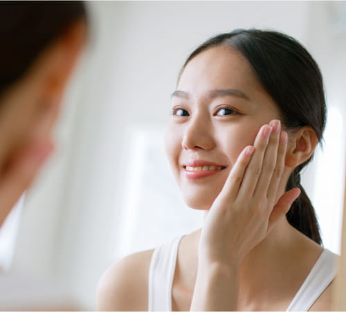 Woman looking at the mirror.