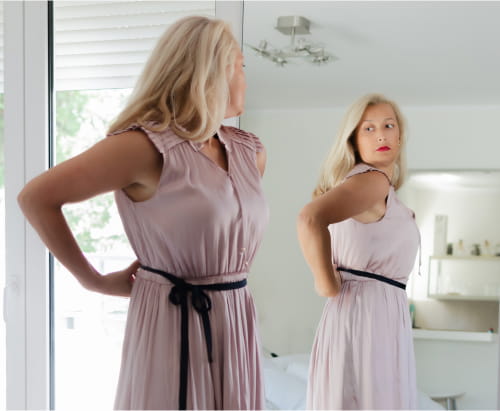 Woman looking at the mirror.